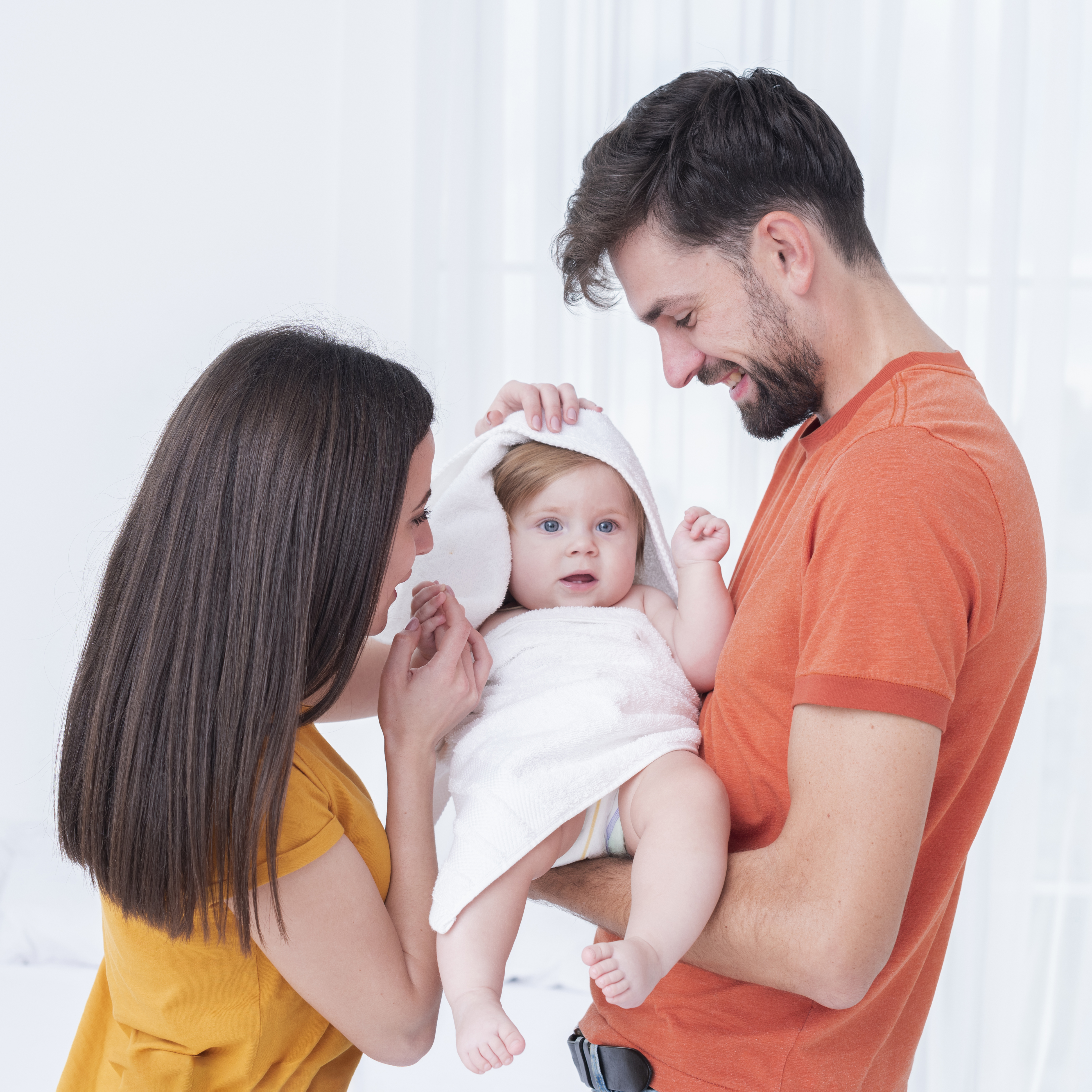 baby-towel-held-by-parents